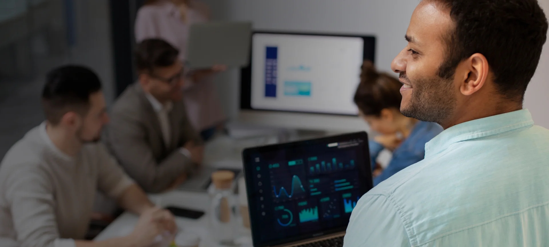 Blue-shirted man showcasing software solutions for business services.