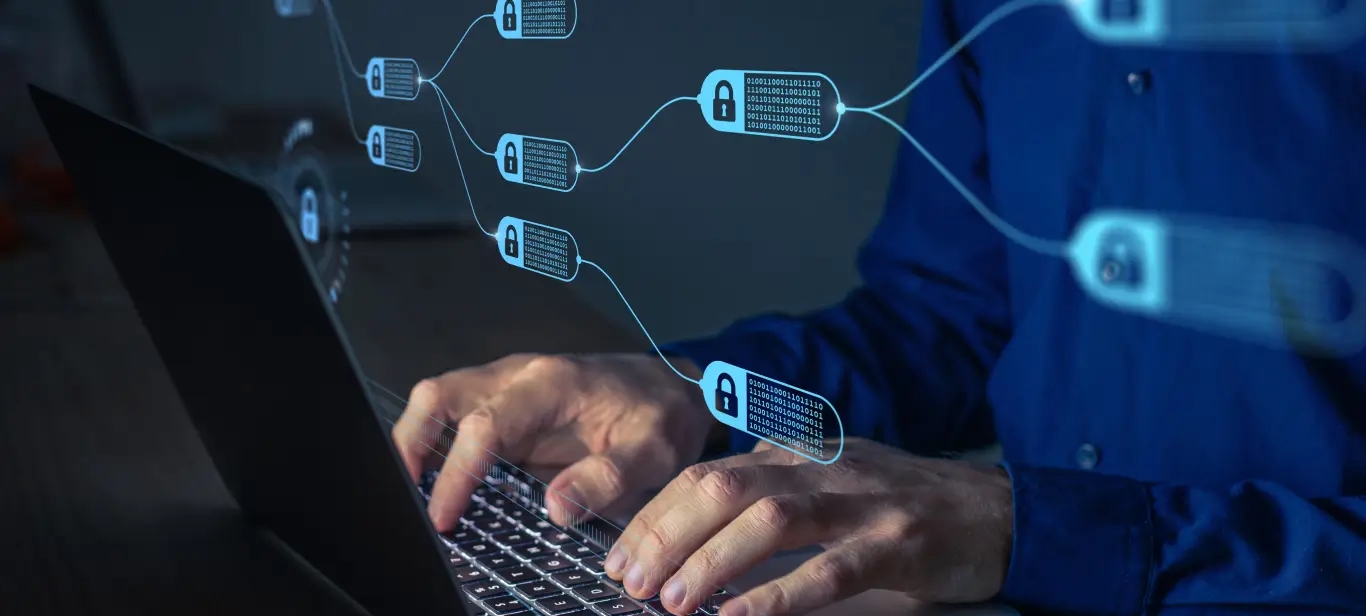 A person typing on a laptop computer with a network diagram, showcasing cybersecurity solutions.