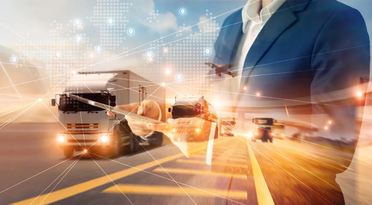 Businessman with tablet displaying truck on road - IT solutions for logistics and transportation.