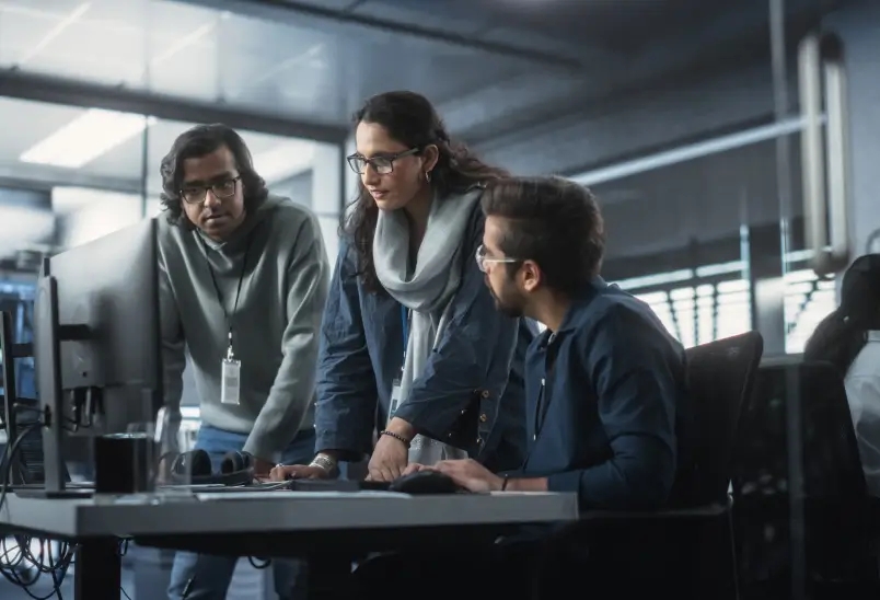 Group of three individuals collaborating.